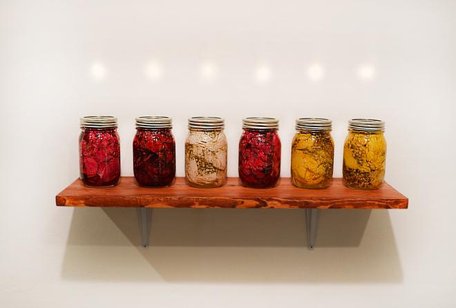 canning jars filled with roses, baby's breath, sugar, and vinegar