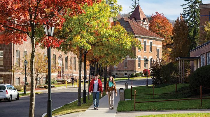 students walking down academic alley on a fall sunny day